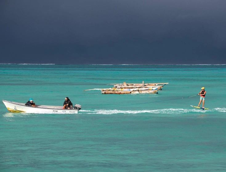 Zanzibar ProKite instructors and student foiling on the lagoon in Jambiani
